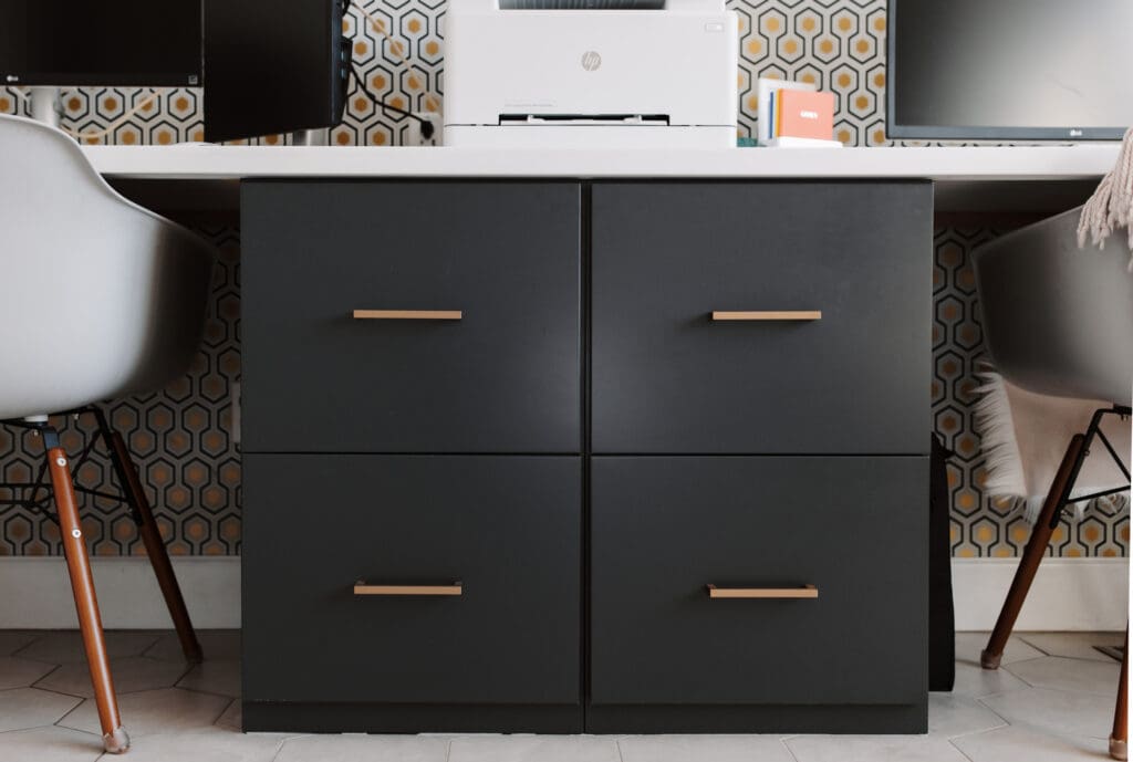 Charcoal Woodharbor office cabinets with slab drawers and Top Knobs brass hardware